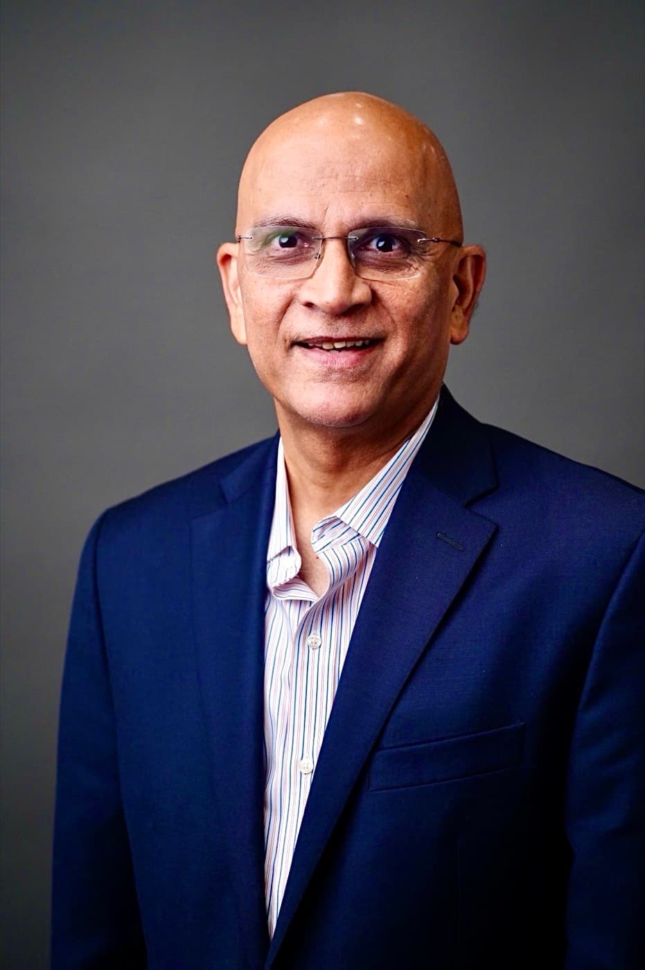 Dr. Parag H. Mehta, smiling in a navy suit and glasses